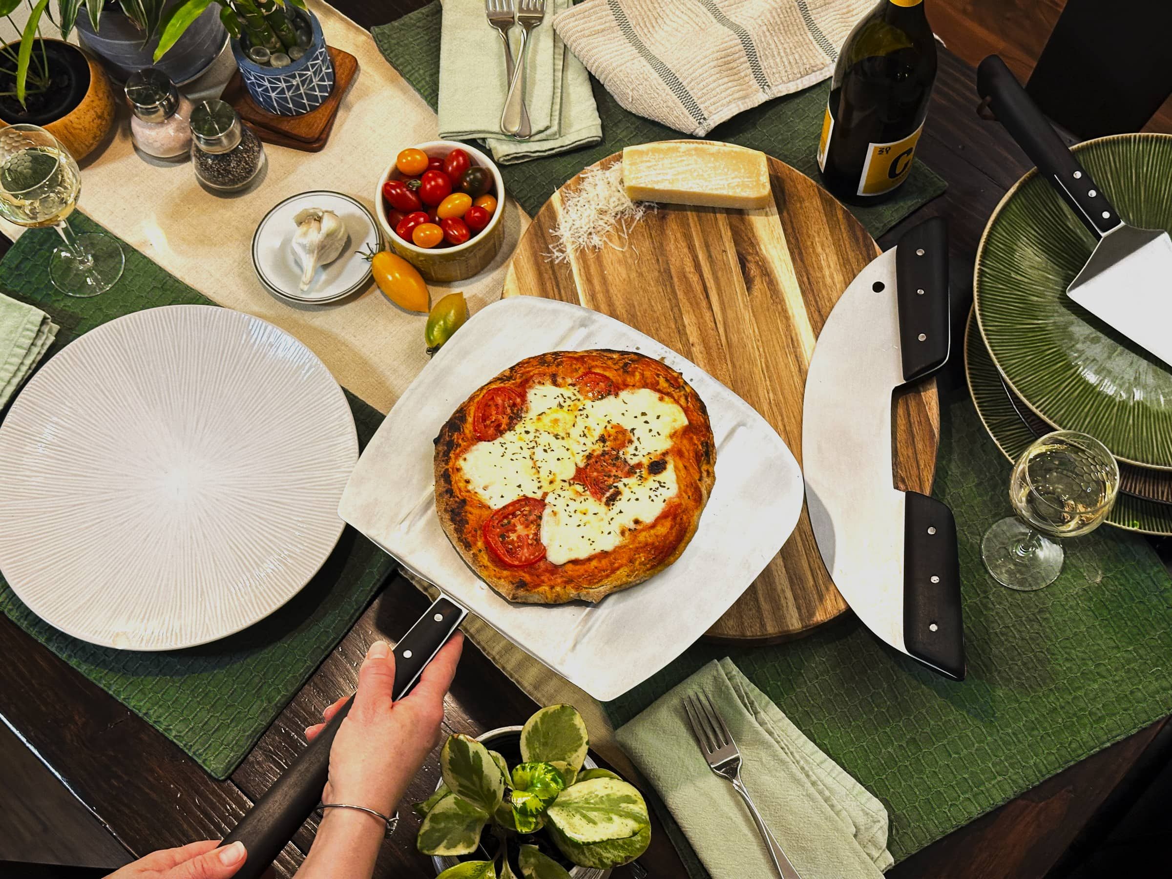 The Noir tools in use at a dinner table with a fresh pizza