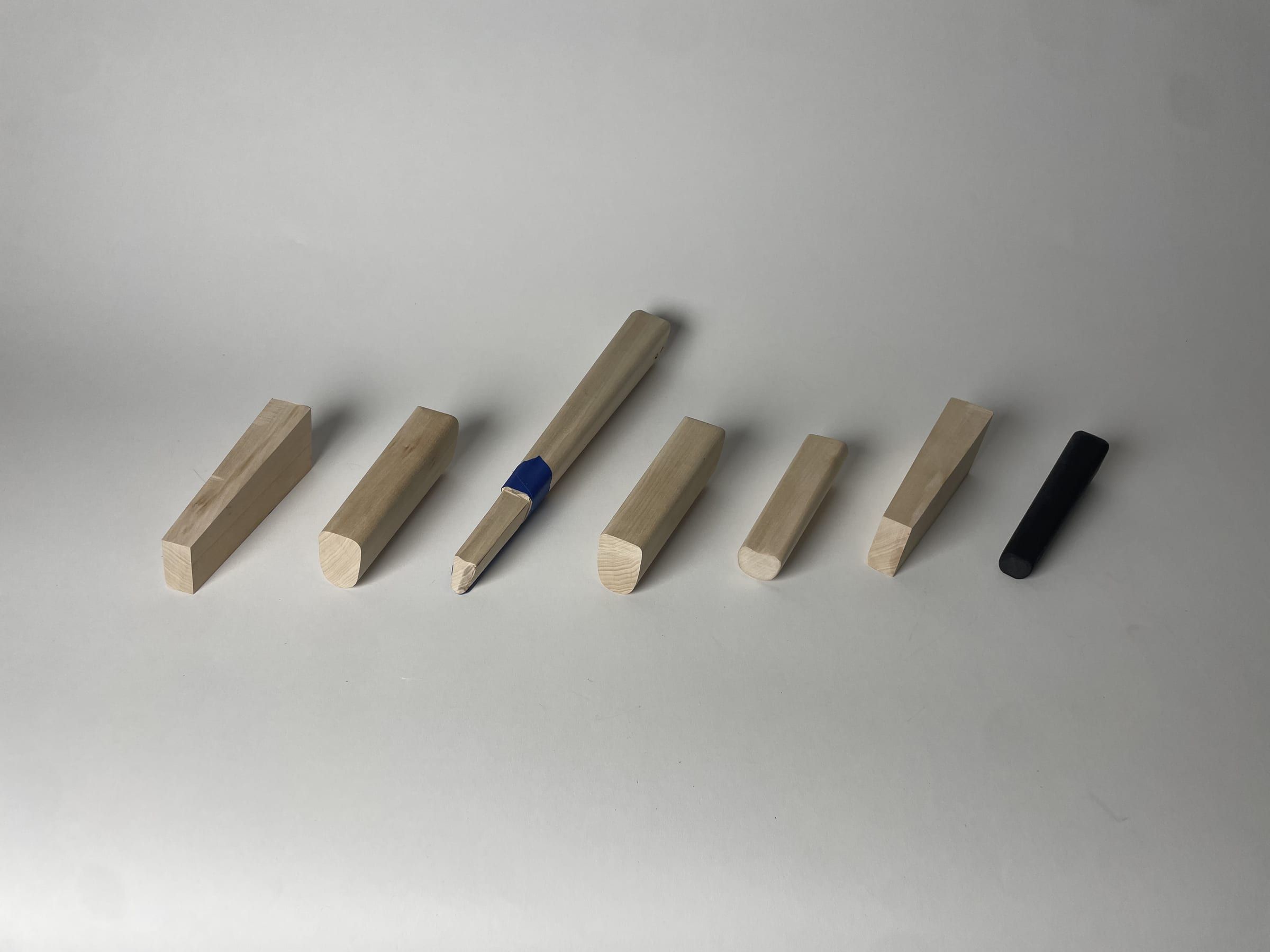 A row of wooden handle iterations