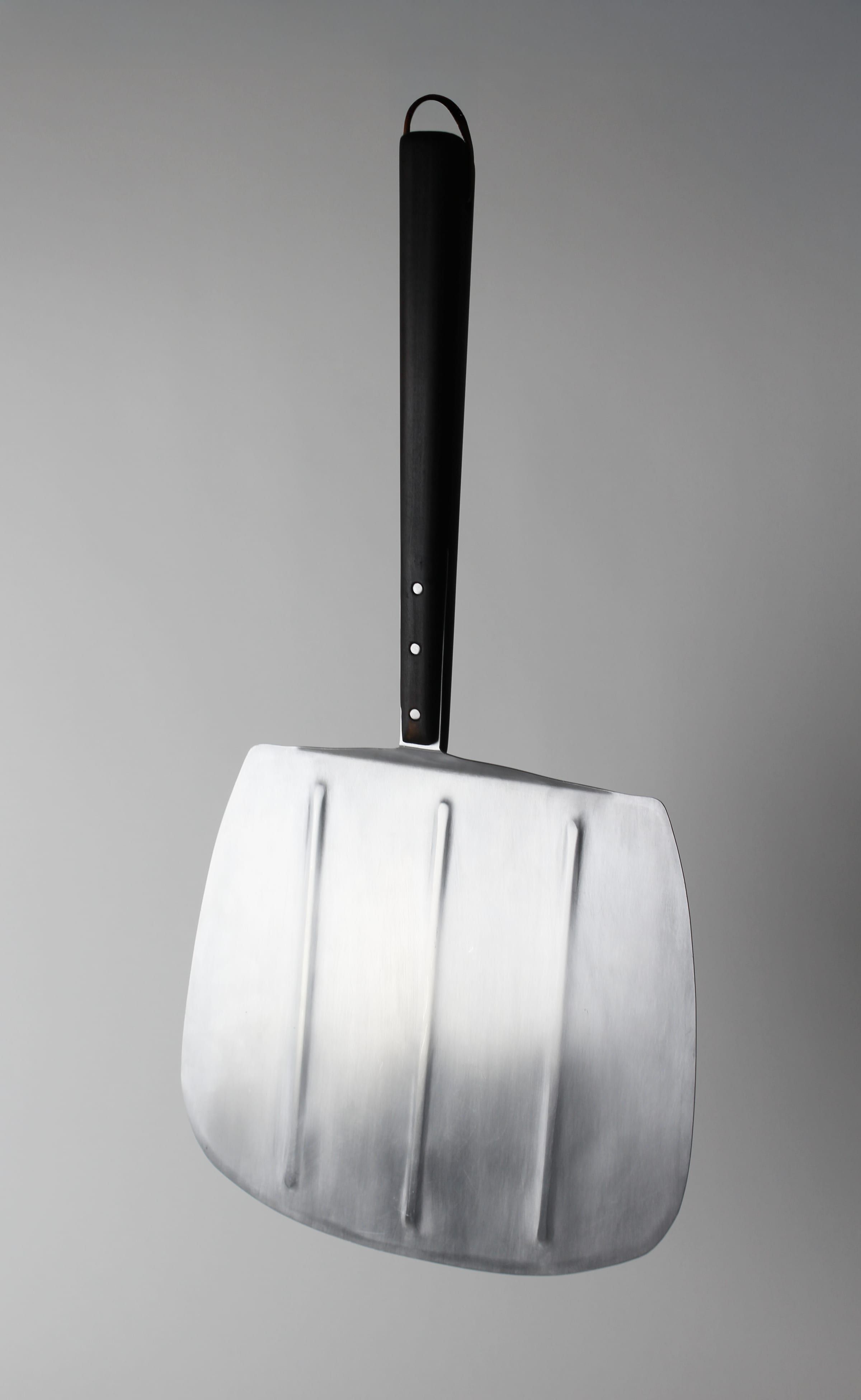 The peel hanging from its leather loop